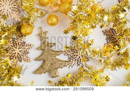 Golden Christmas Tree Onament With Garland And Tinsel On White Background, Flat Lay Style