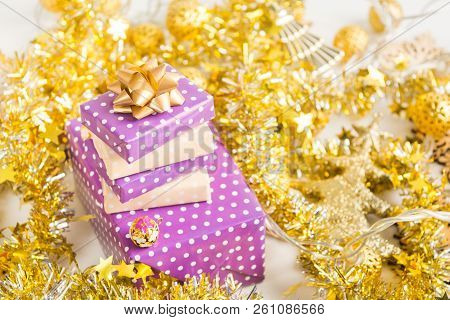 Beige And Violet (purple) Gift Boxes (presents) Stack With Ribbon With Golden Christmas Decoration