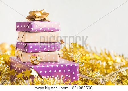 Beige And Violet (purple) Gift Boxes (presents) Stack With Ribbon With Golden Christmas Decoration