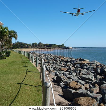 Colourful Coastal Landscape Seascape, Scenic View Of A Commercial Passenger Jet Airliner Flying High