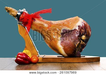 Parma Ham (jamon) On A Wooden Stand Isolated On Blue Background