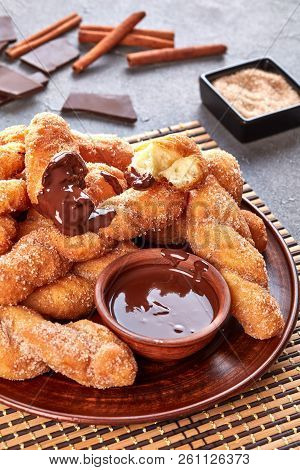 Twisted Korean Doughnuts - Kkwabaegi Sprinkled With Sugar And Dipped In Melted Chocolate Served On A