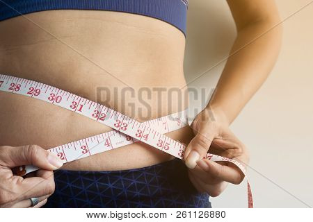 Woman Measuring Fat On Belly. Get Rid Of Belly Fat