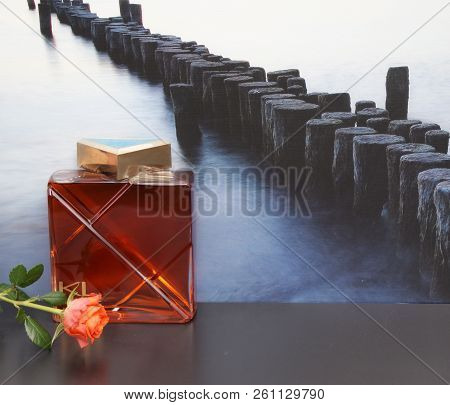 Kl Homme, Mens Fragrance, Large Perfume Bottle In Front Of The Picture Of A Groyne In The Sea Decora
