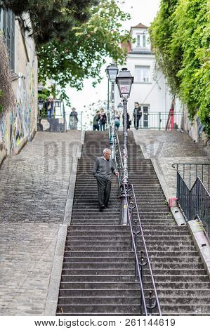 Paris, France - May 12, 2017: An Elderly Man Walking Down A Staricase In Famous Montmartre District