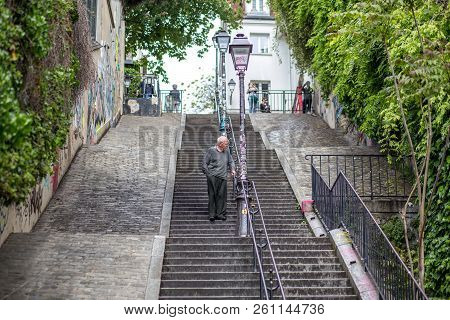 Paris, France - May 12, 2017: An Elderly Man Walking Down A Staricase In Famous Montmartre District