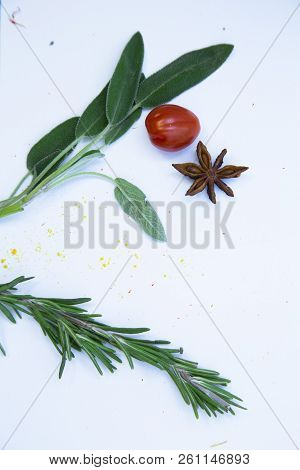 Dry Spices And Herbs In Glass Jar With A Cork, A Bowl Of Cherry Tomatoes And Chili Peppers, White Ba