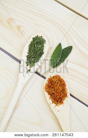 Cooking Hot Spicy Food Concept. Dry Spices, Beans And Herbs In Wooden Spoons On Light Wooden Table