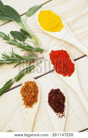 Cooking Hot Spicy Food Concept. Dry Spices, Beans And Herbs In Wooden Spoon And Plastic Cup On Light