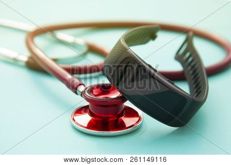 Healthcare Concept. Fitness Watch Activity Tracker And Sthetoscop Over Blue Background.