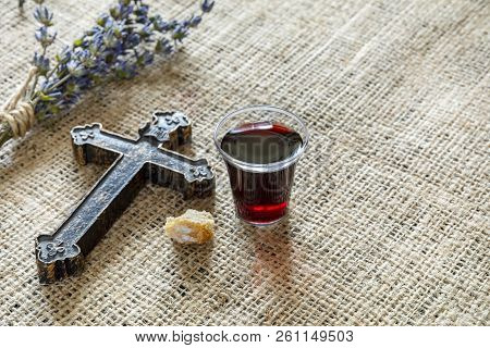 Taking Communion With Glass Of Wine And Bread Near Cross And Lavanda On The Textile Tablecloth.