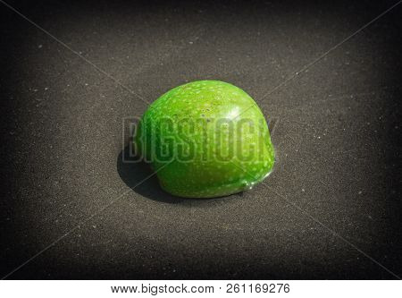 Green Apple In The Sand On The Beach