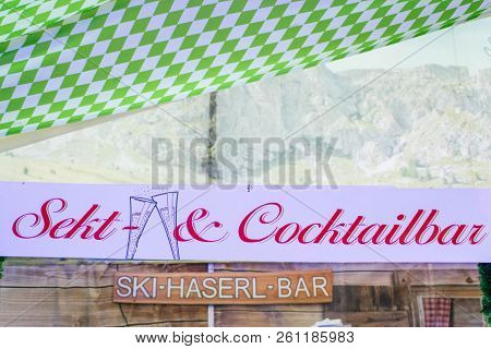 Wooden Signs From At The German Oktoberfest Referring To Champagne-sekt And Cocktails Area Where Peo