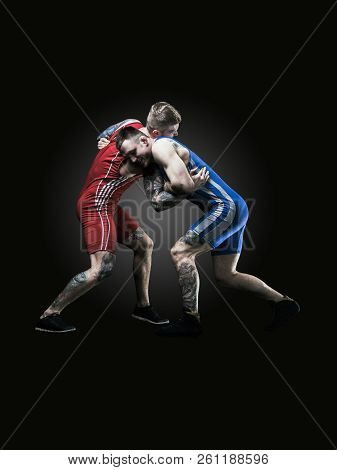 Two Wrestlers Figting Isolated On Black Back