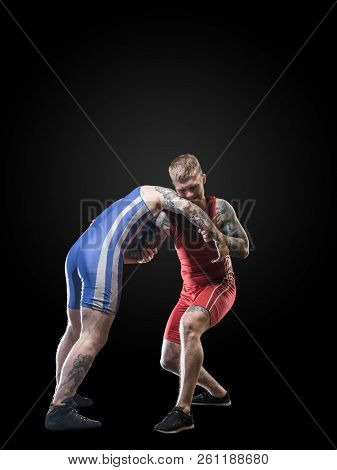 Two Wrestlers Figting Isolated On Black Back