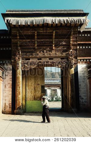 Labrang Monastery, Xiahe, Gansu Province / China - Jun 6 2011: Elderly Pilgrim Man Walking Past By T