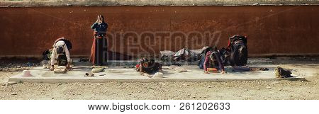 Labrang Monastery, Xiahe, Gansu Province / China - Jun 6 2011: Pilgrim Woman Are Praying Outside Of 