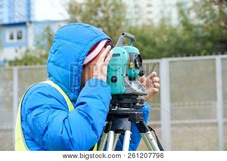 Civil Engineer Land Survey With Tacheometer Or Theodolite Equipment. Worker Checking Construction Si