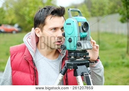 Civil Engineer Land Survey With Tacheometer Or Theodolite Equipment. Worker Checking Construction Si
