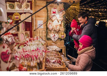 Father And Two Daughters On Christmas Market At St. Stephen's Square In Front Of The St. Stephen's B