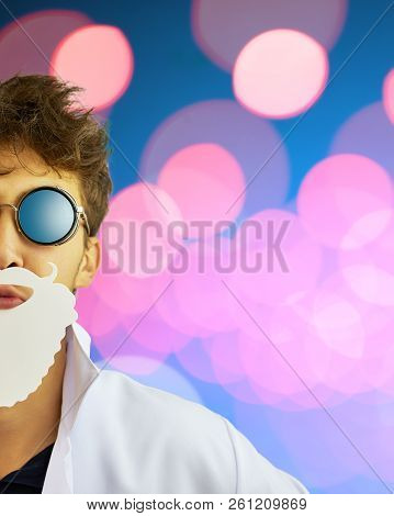 Mad Chemist. A Person In White Coat On Blue Background With Bright Red Lights. Copy Space For Text. 