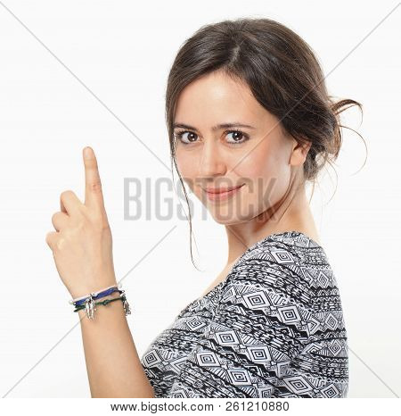 Beautiful Smiling Brunette Pointing Forefinger Up, Isolated