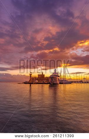 Agios Nikolaos fortress on the Mandraki harbour of Rhodes Greece at dusk