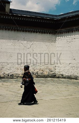 Labrang Monastery, Xiahe, Gansu Province / China - Jun 6 2011: Elderly Tibetan Buddhist Pilgrim Woma