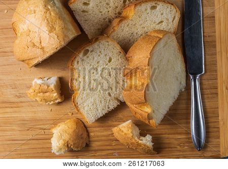 Flat Lay View Of Baked Homemade White Wheet Bread On Wooden Desk.