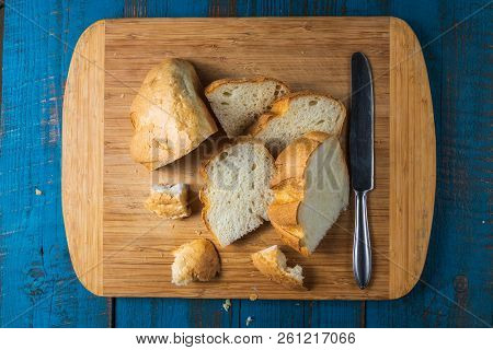 Flat Lay View Of Baked Homemade White Wheet Bread On Old Blue Wooden Desk.