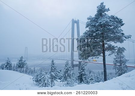 View At Hoga Kusten Bridge In Winter In Sweden. Hoga Kusten Suspension Bridge In Sweden. Cloudy Wint