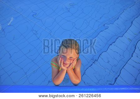 Cute Little Girl In The Public Swimming Pool. Portrait Of Little Cute Girl In The Swimming Pool. Sun