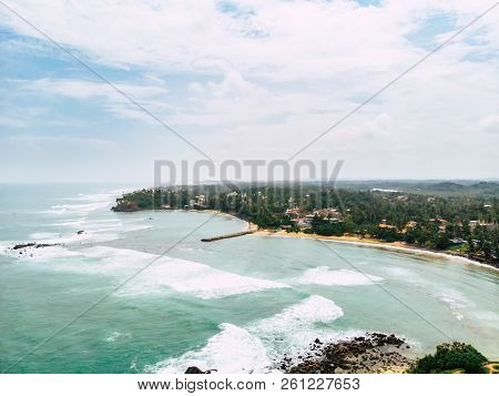 Top View Of Beautiful White Sand Beach With Turquoise Sea Water And Palm Trees, Aerial Drone Shot