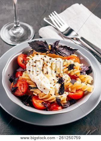 Tasty Italian Fusilli Pasta With Cherry, Mozarella Or Buratta Cheese And Fresh Basil. Dish With Past