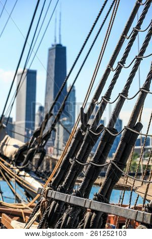 Rigging and ropes on a historic sailing ship downtown Chicago skline in the background