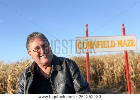 Smiling middle aged man at a corn maze