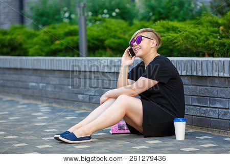 Young Girl Freelancer, Student In Sunglasses Plus Size Outdoors, Talking On The Phone, Laughing, Hap