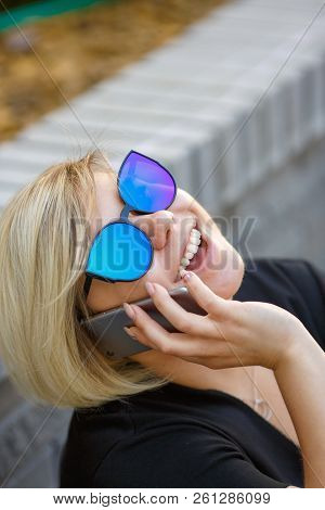 Portrait Young Girl Student In Sunglasses Plus Size Sits In The Yard, Sits On Campus Talking On The 