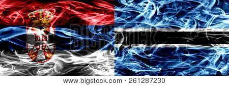 Serbia Vs Botswana, Botswanan Smoke Flags Placed Side By Side. Thick Colored Silky Smoke Flags Of Se