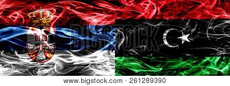 Serbia Vs Libya, Libyan Smoke Flags Placed Side By Side. Thick Colored Silky Smoke Flags Of Serbian 