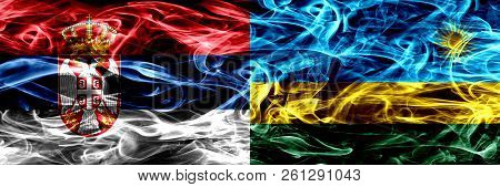 Serbia Vs Rwanda, Rwandan Smoke Flags Placed Side By Side. Thick Colored Silky Smoke Flags Of Serbia
