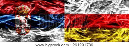 Serbia Vs South Ossetia Smoke Flags Placed Side By Side. Thick Colored Silky Smoke Flags Of Serbian 