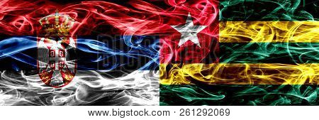 Serbia Vs Togo, Togolese Smoke Flags Placed Side By Side. Thick Colored Silky Smoke Flags Of Serbian