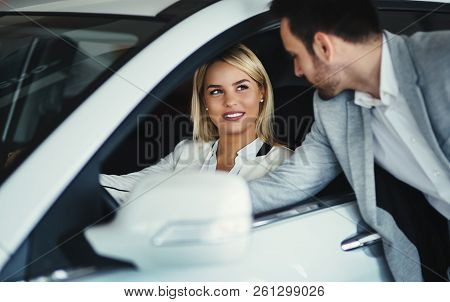 Handsome Salesman At Car Dealership Selling Vehichles