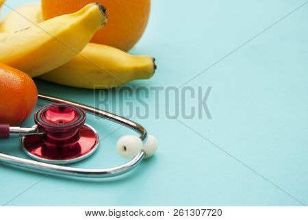 Medicine And Healthcare, Nutrition Or Medical Insurance Over Blue Background. Fruits And Red Sthetos