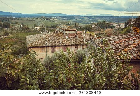 Italian Medieval Town With Roofs Of Mansions At Evening Landscape Of Tuscany. Green Garden Trees, Hi
