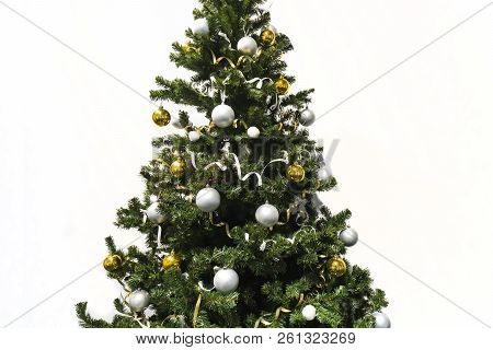 Decorated Christmas Tree Isolated On White Background. Christmas Tree Decorated With Yellow And Whit