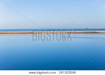 Scenic River Lagoon Glass Smooth Mirror Waters With Distant Stand Up Paddler Board Paddling Towards 