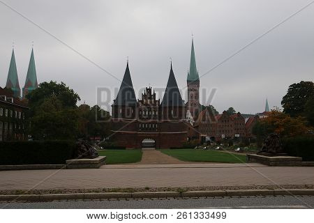 Beautiful Skyline From Luebeck With The Holsten Gate At A Rainy Day