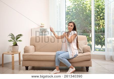 Young Woman Suffering From Heat At Home. Air Conditioner Malfunction